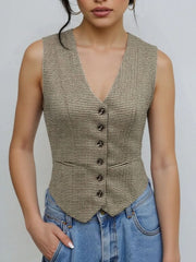 Woman wearing a plaid button down vest with lined interior and normal thickness for stylish comfort.