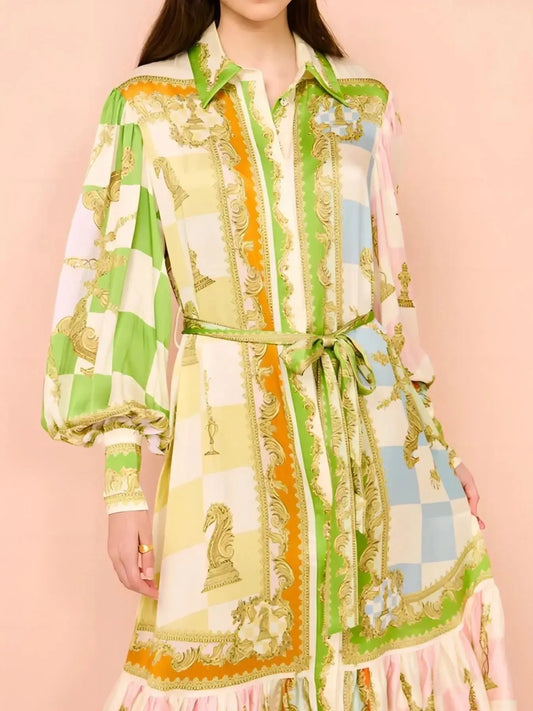 Printed tie waist lantern sleeve dress with pastel stripes and gold accents, button-down front, and balloon sleeves.