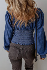 Back view of Smocked Long Sleeve Denim Top highlighting the cinched waist and ruffled hem, ideal for casual chic styling.