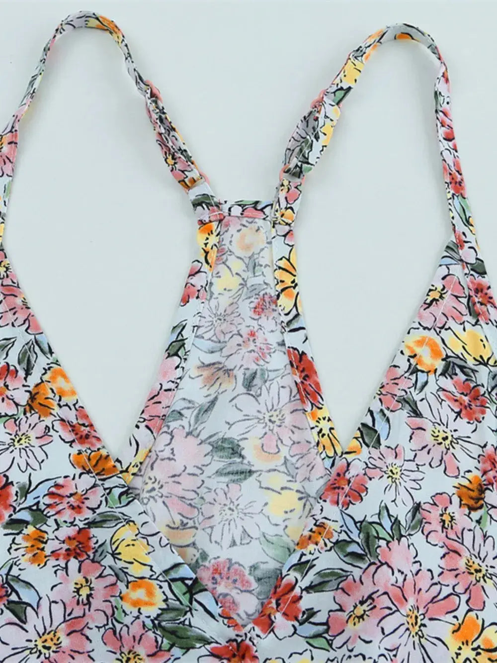 Close-up of back straps on Floral Surplice Cami Tops & Tees GirlSavvi showcasing floral fabric and T-back design.