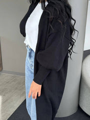 Side view of Perfee Open Front Dropped Shoulder Cardigan paired with light-wash jeans, showcasing its relaxed fit and ribbed cuffs.