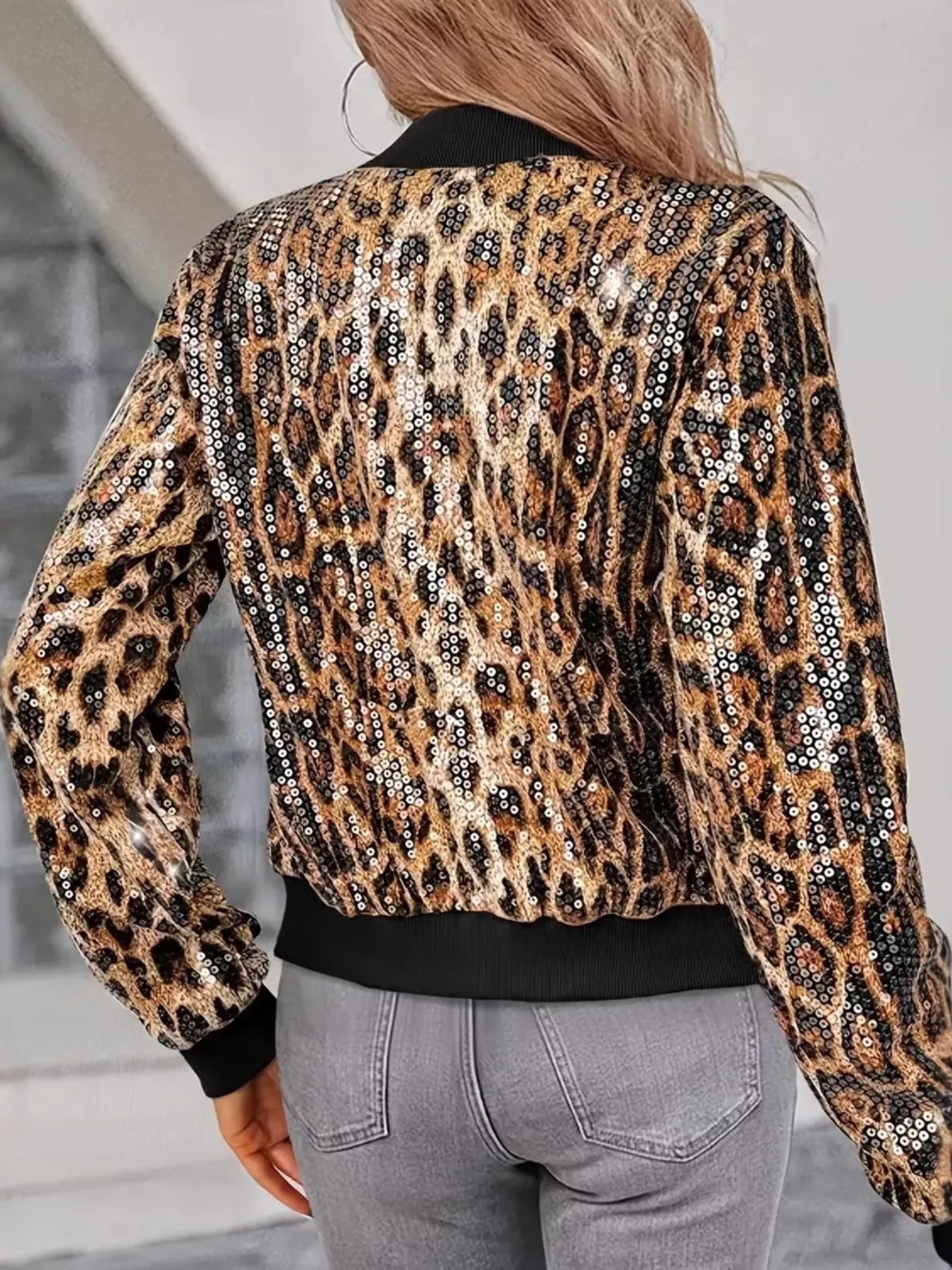 Woman wearing GS Sequin Leopard Zip Up Jacket with bold leopard print and sequins