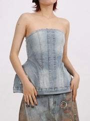 Woman wearing a Zip Back Denim Tube Top with a structured design and modern denim finish, showcasing the strapless and sleek silhouette.
