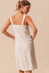 Back view of SO ME button down pinafore dress showing square neckline and elastic waist detail in soft cotton fabric.