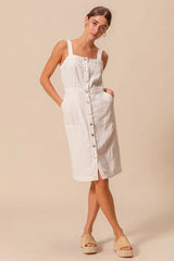 Casual cotton pinafore dress with front buttons and large pockets, perfect for everyday wear or layering.