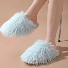 Model wearing light blue fluffy round toe flats slippers with comfy PVC sole, perfect for cozy indoor fashion.
