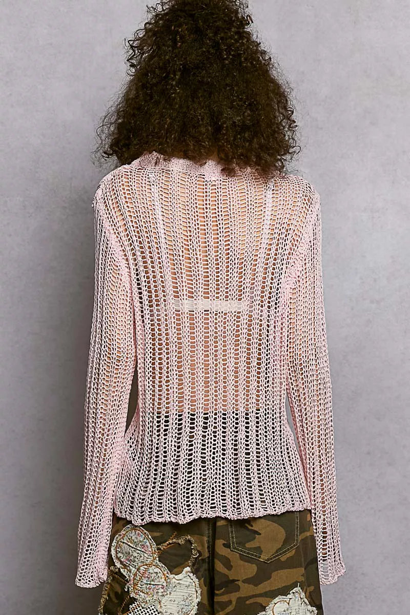Back view of a POL Openwork Round Neck Knit Cover Up with an open-knit pattern, pink color, worn by a person with curly hair.