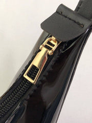 Close-up of black PU Leather PVC Shoulder Bag zipper with gold hardware, highlighting quality craftsmanship and detail.