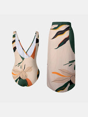 Back view of FAM-FAM Printed Surplice Wide Strap Swimwear and Skirt Swim Set showing the low-back swimsuit and high-waisted skirt with tropical patterns.