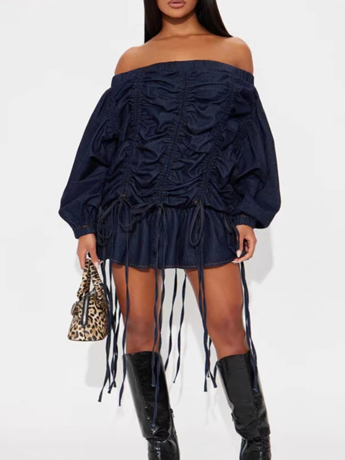 Off-Shoulder Ruched Denim Dress featuring ruched details and drawstrings, styled with a chic handbag.