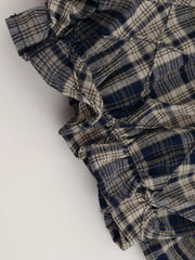 Close-up of ruched design on Drawstring Plaid Skort with blue and white plaid pattern.