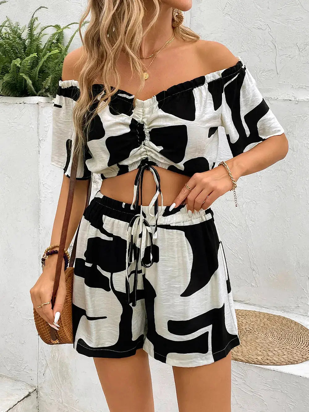 Chic Perfee Drawstring Off-Shoulder Top and Shorts Set in black and white with drawstring accents, ideal for warm-weather outfits.