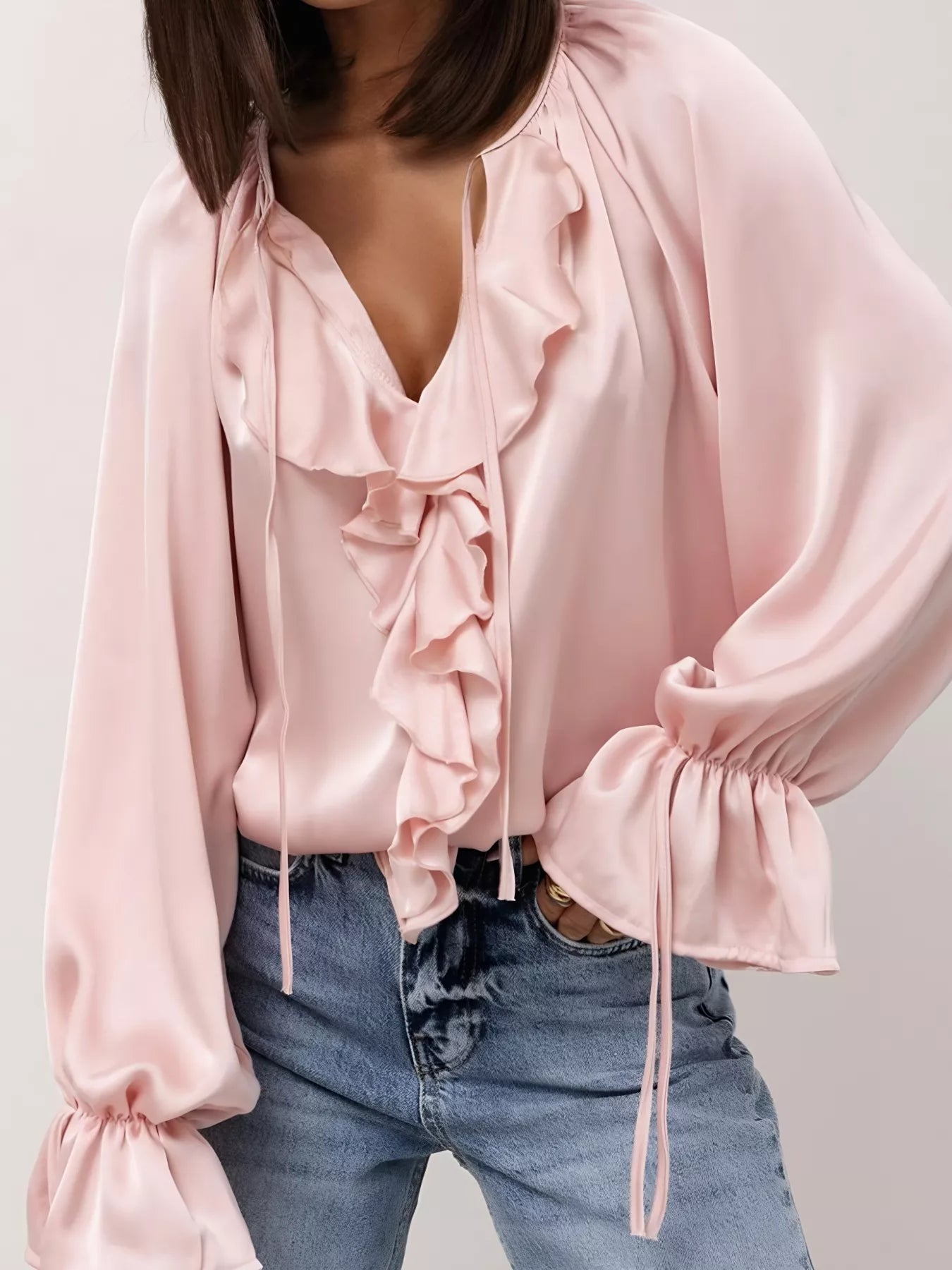 Ruffle Trim Satin Flounce Sleeve Blouse in pink with tie-neck detail and ruffled front, styled with denim for a day-to-night look.