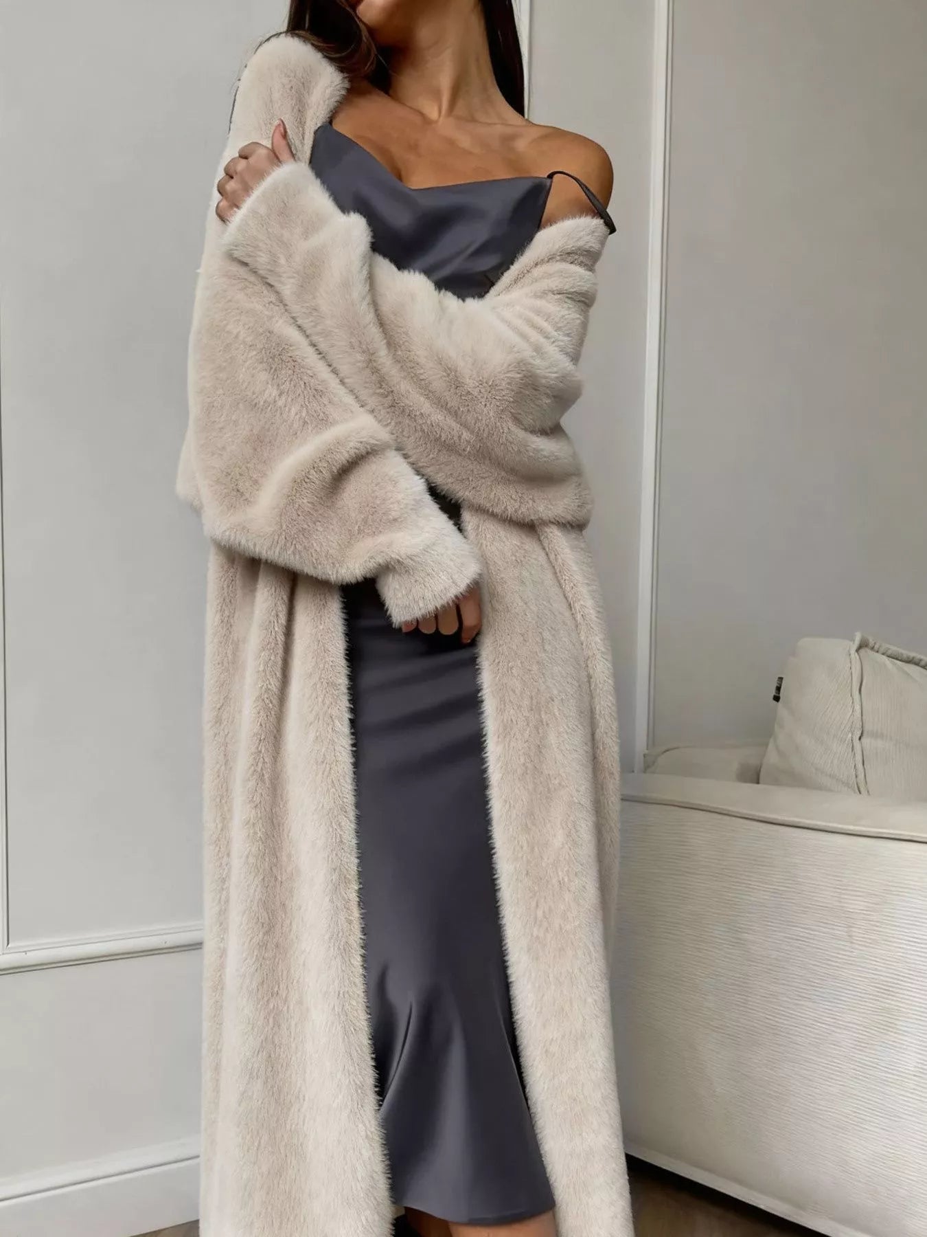 Woman wearing Fuzzy Open Front Longline Cardigan over a dress, showcasing soft texture and relaxed fit for easy layering.
