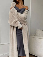 Woman wearing Fuzzy Open Front Longline Cardigan over a dress, showcasing soft texture and relaxed fit for easy layering.