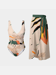 FAM-FAM Printed Surplice Wide Strap Swimwear and Skirt Swim Set featuring a floral abstract print with a deep V-neck one-piece and matching wrap skirt.