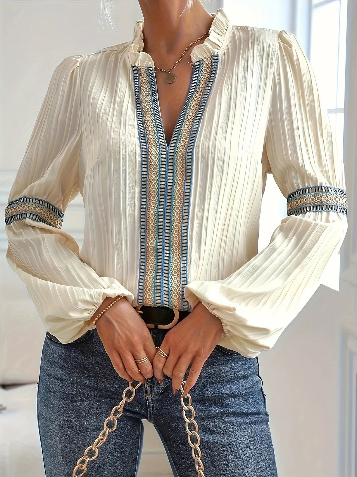 Notched Textured Balloon Sleeve Blouse with pleats and embroidered trim, featuring a frill neckline and ruched accents for an elegant look.