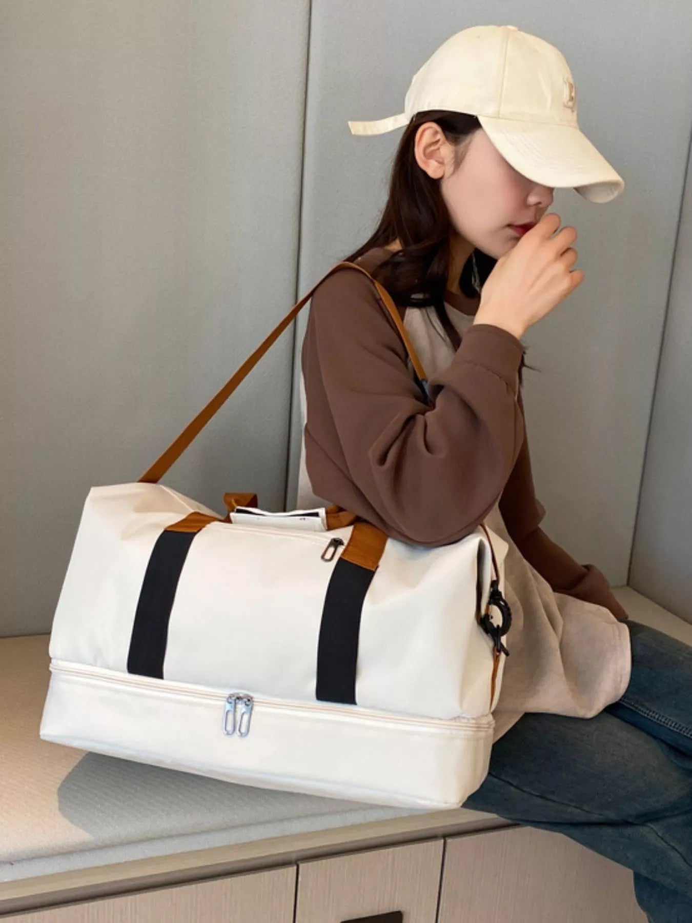 Woman with Multifunctional Waterproof Travel Duffel Bag in white, perfect for travel and gym use.