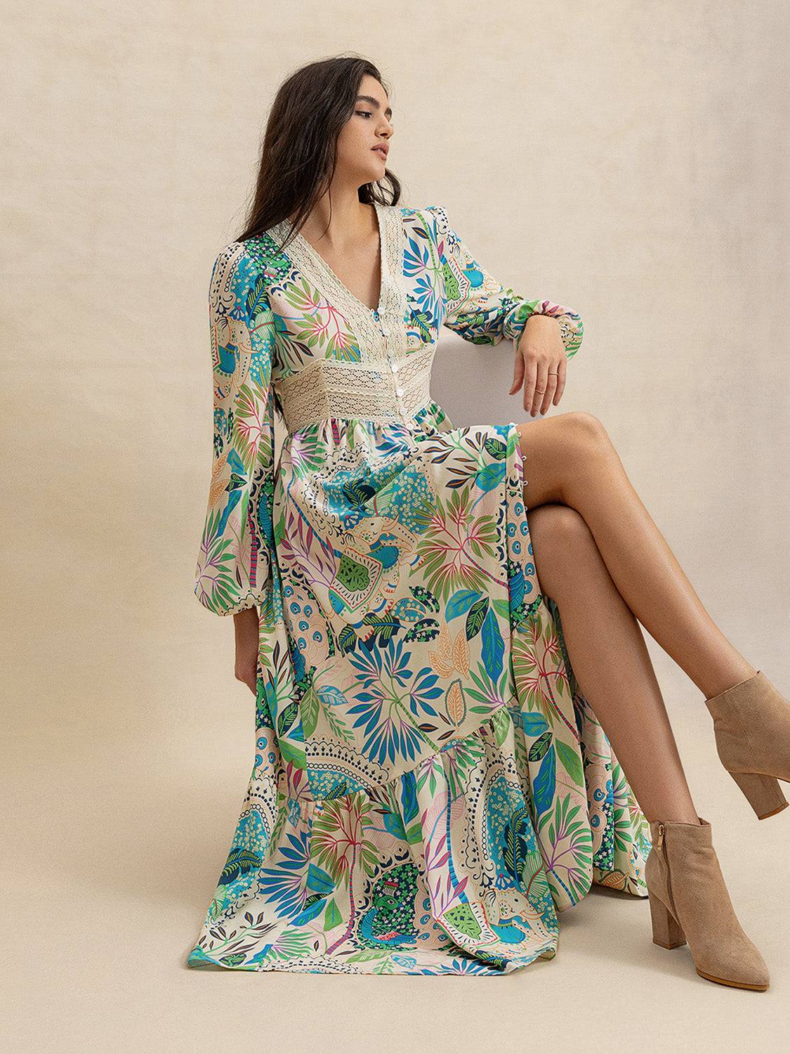 Effortlessly Chic Slit Printed V-Neck Long Sleeve Midi Dress styled seated, showcasing front slit and colorful botanical print.