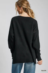 Back view of a woman wearing an Umgee Wool Blended Pullover Sweater in black, showcasing the oversized fit and long sleeves.