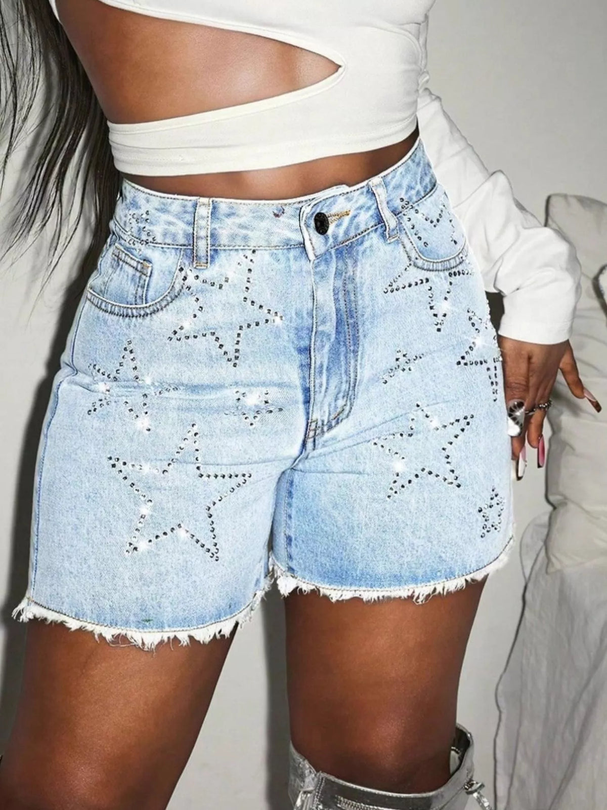 Star Raw Hem Denim Shorts featuring frayed edges and star embellishments, perfect for casual sporty outfits.