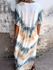Back view of beige and teal Tie-Dye Pocketed Dress. Features relaxed fit, side pockets, and soft polyester-spandex fabric.