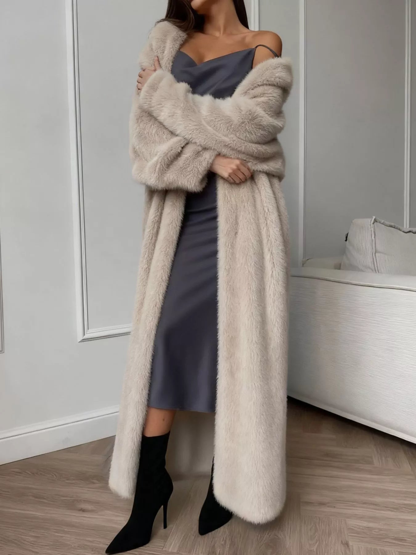 Woman wearing Fuzzy Open Front Longline Cardigan over a dress, standing in a stylish indoor setting.
