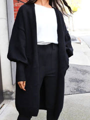 Black Perfee Open Front Dropped Shoulder Cardigan styled with monochrome outfit, highlighting its oversized sleeves and open front design.