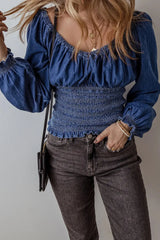 Denim Smocked Long Sleeve Top paired with high-waisted jeans, showcasing a stylish and comfortable summer wardrobe staple.