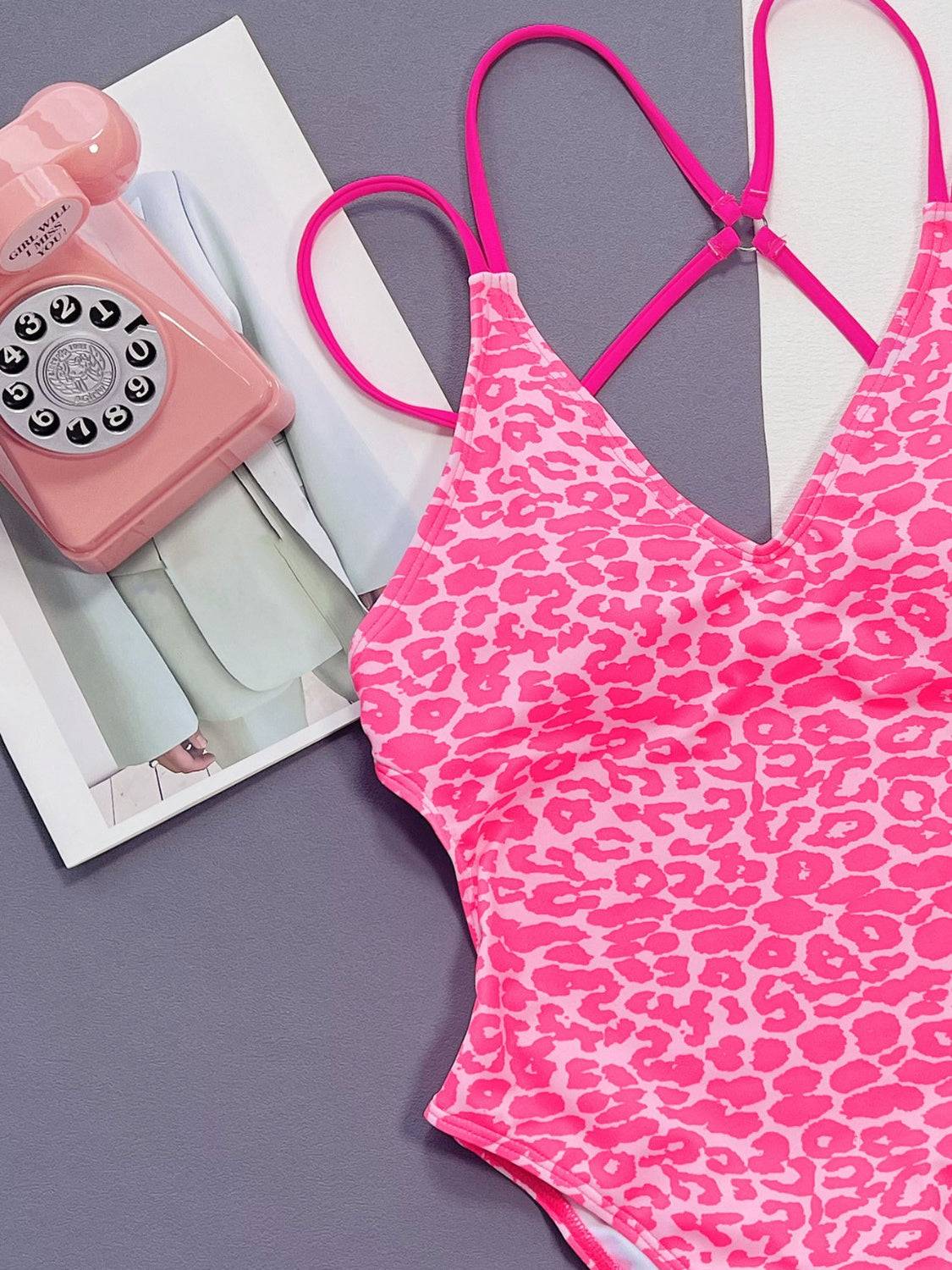 Close-up of pink Leopard Plunge Swimwear highlighting double spaghetti straps and bold animal print pattern.