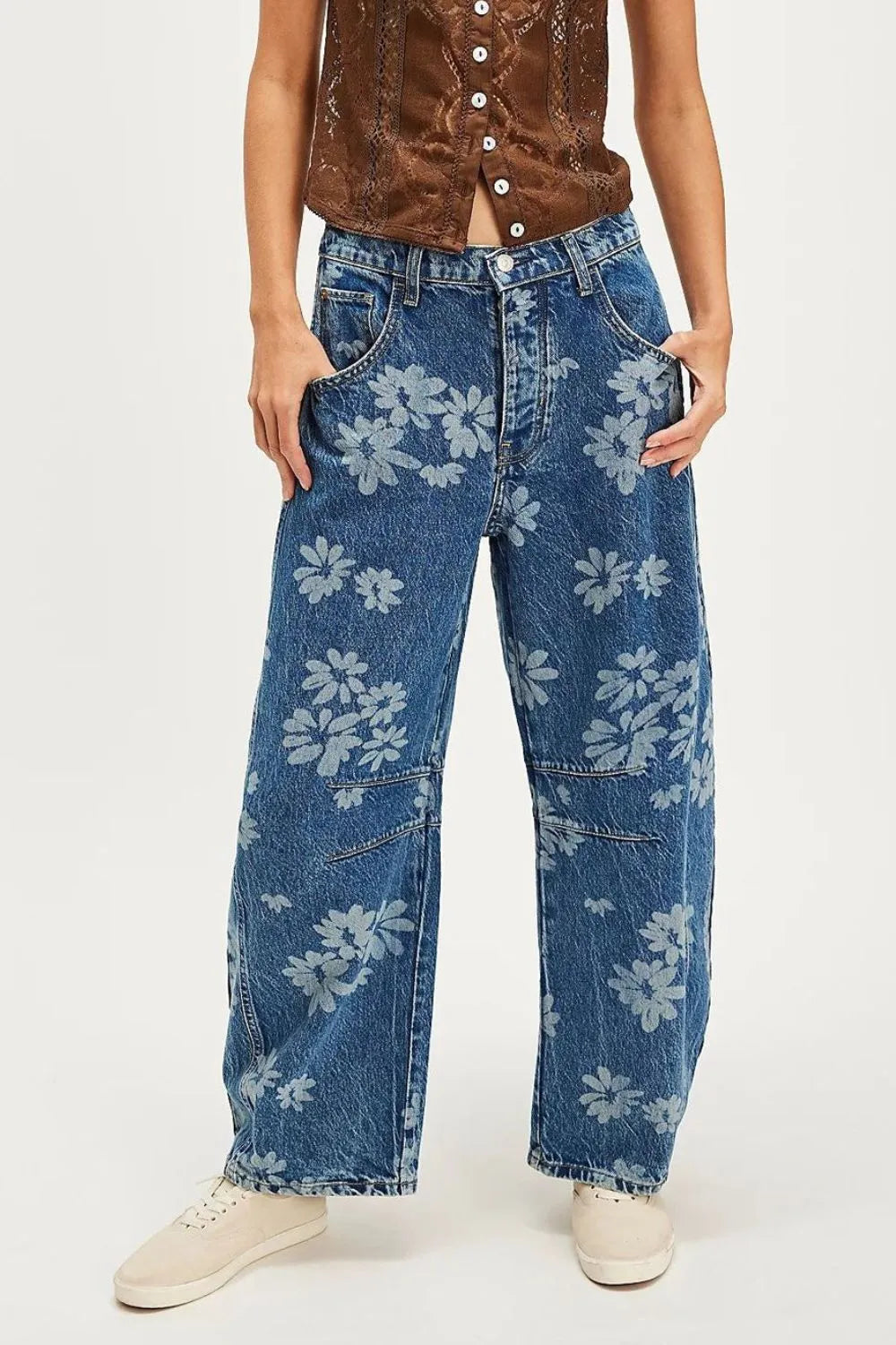 Model wearing Flower Print Wide Leg Pants with a soft floral print on denim, showcasing a relaxed silhouette and functional pockets.