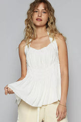 Woman wearing POL Backless Halter Sleeveless Top with Smocking Shirring Detail in white.