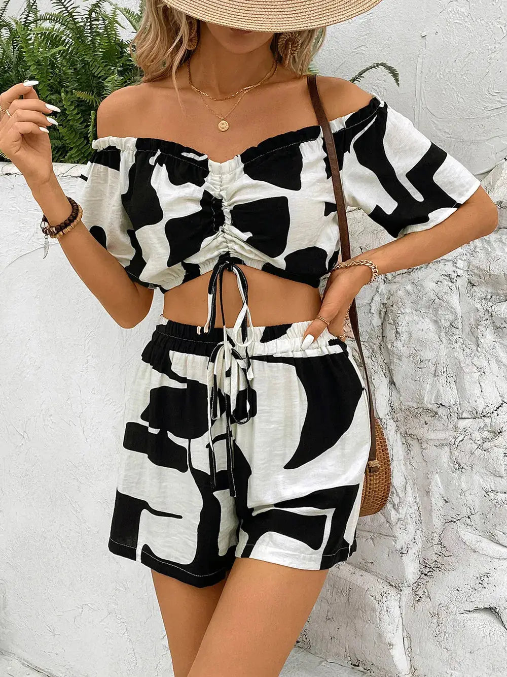 Trendy Perfee Drawstring Off-Shoulder Top and Shorts Set with tie-front crop top and high-waisted shorts in monochrome print.