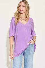Front view of lavender Basic Bae Full Size Bamboo V-Neck Drop Shoulder T-Shirt, styled with light denim for a relaxed outfit.