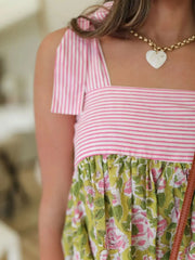 Close-up of Printed Square Neck Tie Shoulder Mini Dress showing pink striped square neckline and floral bodice detail.