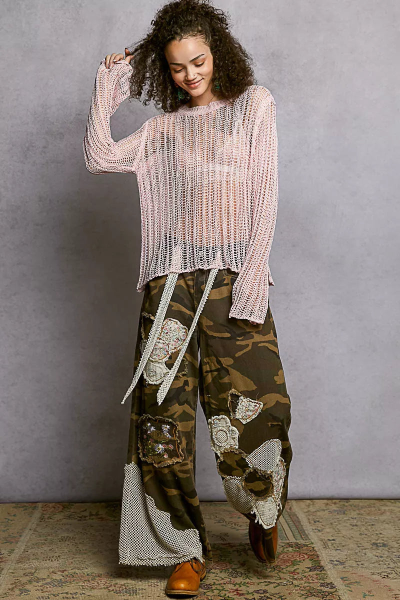 Woman wearing POL Openwork Round Neck Knit Cover Up in pink, paired with patchwork wide-leg pants.