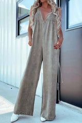 Khaki V-Neck Sleeveless Denim Jumpsuit with Pockets, styled with white shoes for a casual, comfortable fashion statement.