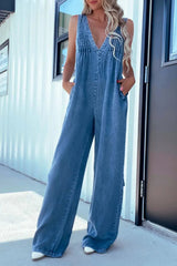 V-Neck Sleeveless Denim Jumpsuit with Pockets in light blue, styled with white heels for a modern, effortless look.