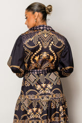 Woman wearing Resort Wear Maxi Dress with gold baroque patterns on a deep backdrop, perfect for elegant vacation occasions.