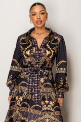 Woman wearing Resort Wear Maxi Dress with gold baroque pattern for luxurious vacation style.