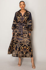 Woman wearing Resort Wear Maxi Dress with gold baroque patterns on a dark backdrop, perfect for luxury vacations and resort events.