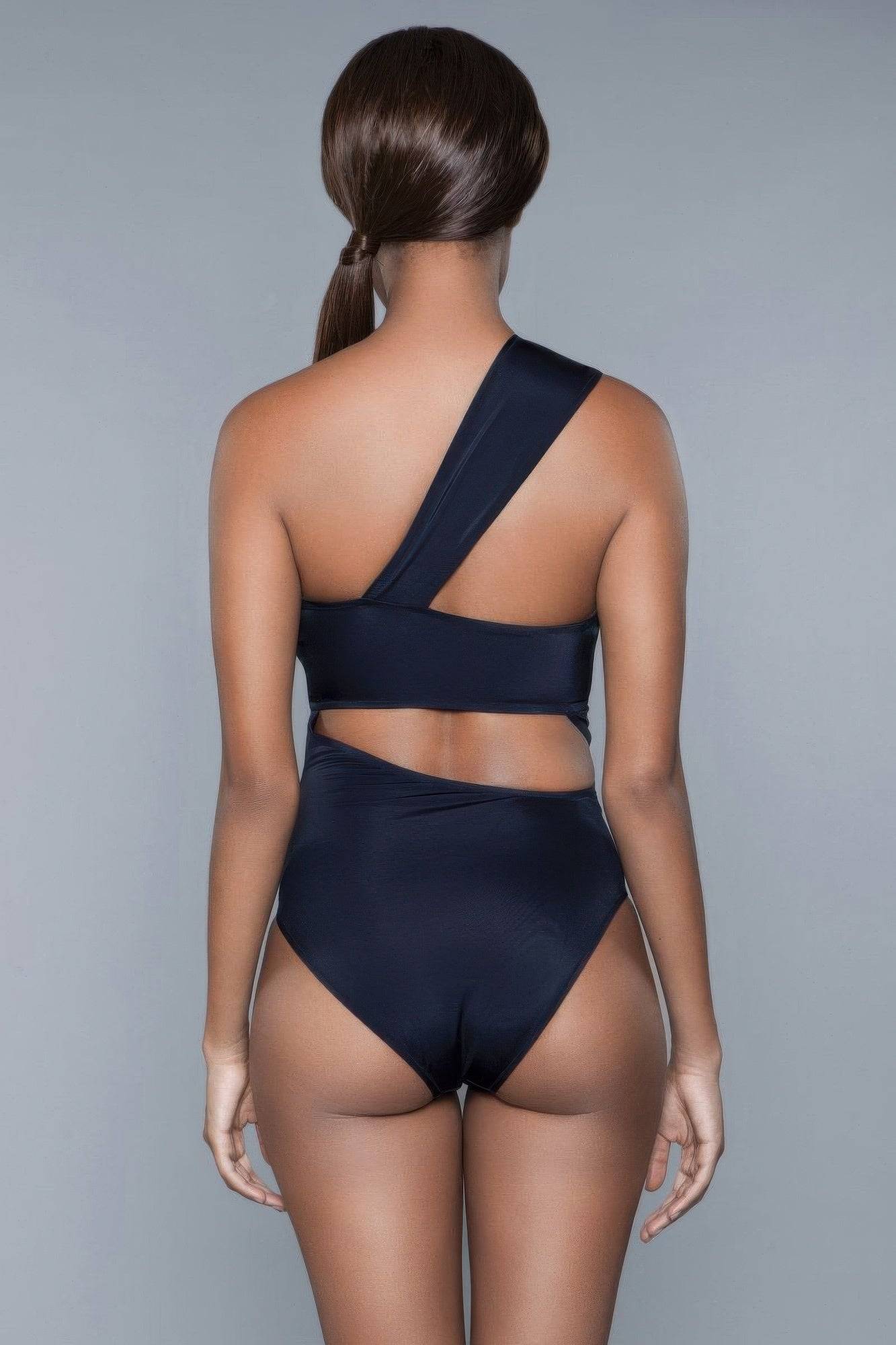 Back view of Kennedy Swimsuit in black, emphasizing asymmetrical strap and cutout back for a sleek and stylish swimwear silhouette.
