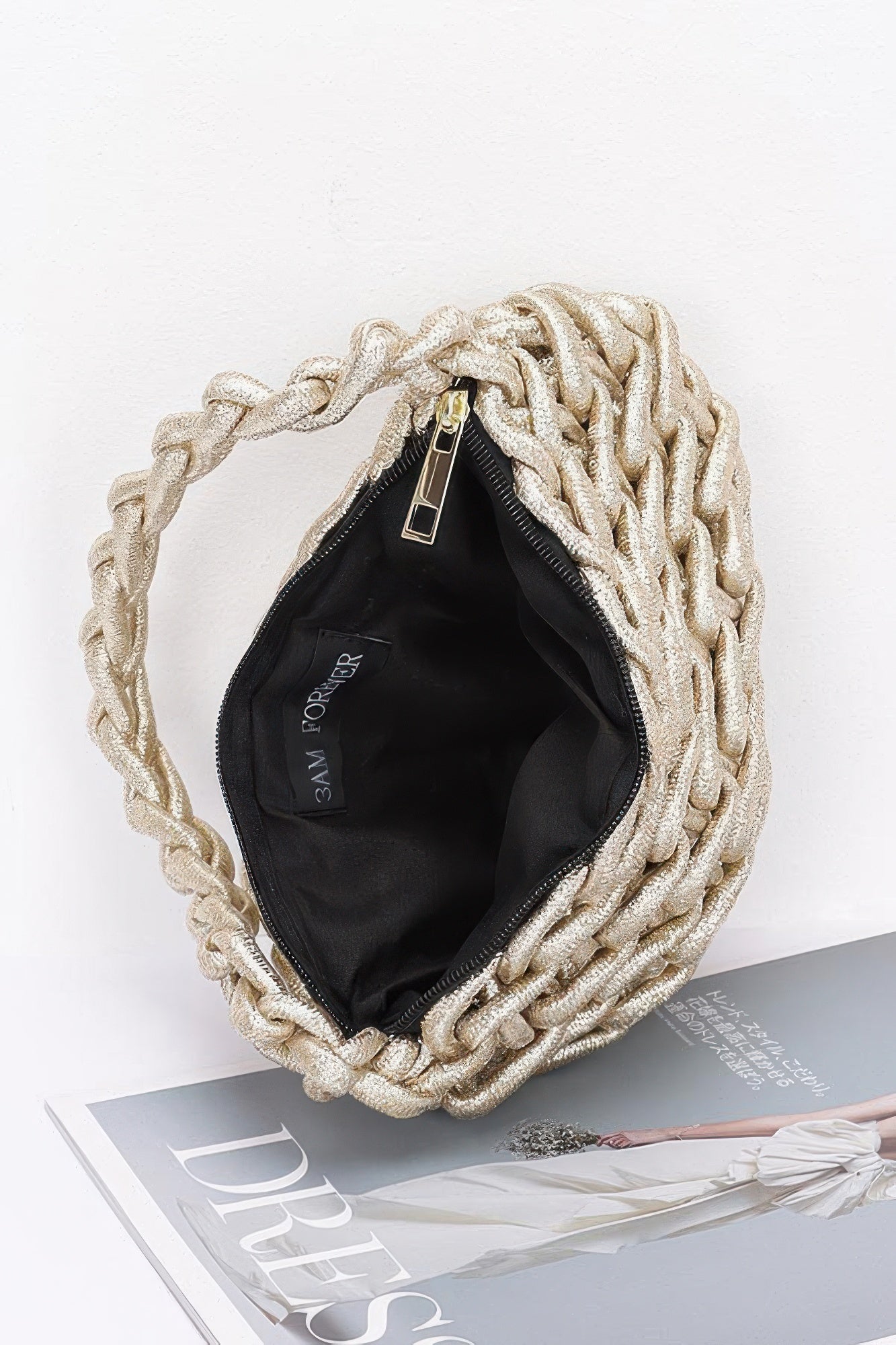 Interior view of the gold Metallic String Handmade Tote Bag showing black fabric lining and gold zipper closure for secure storage.