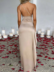 Back view of One Shoulder Satin Dress with High Slit, featuring ruched detailing and elegant satin finish, surrounded by rose petals.