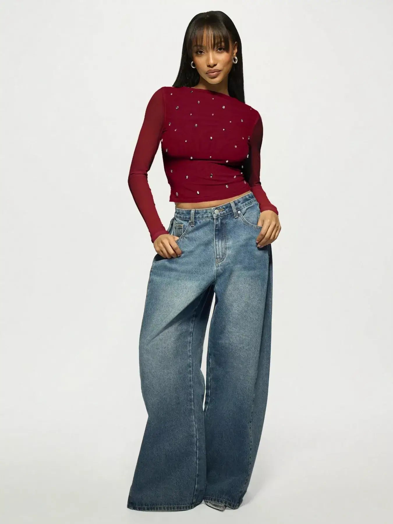 Model wearing Rhinestone Embellished Long Sleeve T-Shirt with wide-leg jeans, showcasing casual yet chic style.