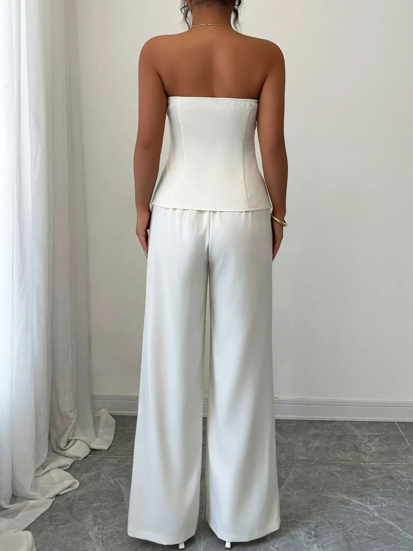 Back view of a stylish tube top and wide-leg pants set in white, perfect for casual outings or brunch dates.