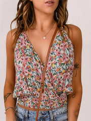 Floral Surplice Cami Tops & Tees GirlSavvi with pink and yellow floral print, deep V-neckline, and smocked waist, styled with denim jeans.