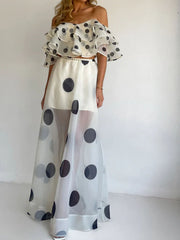 Woman wearing Polka Dot Ruffle Crop Top and Maxi Skirt Set, featuring an off-shoulder ruffle top and flowing high-waisted skirt for summer.