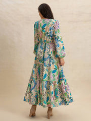 Back view of Effortlessly Chic Slit Printed V-Neck Long Sleeve Midi Dress showing tiered hem and all-over tropical print.
