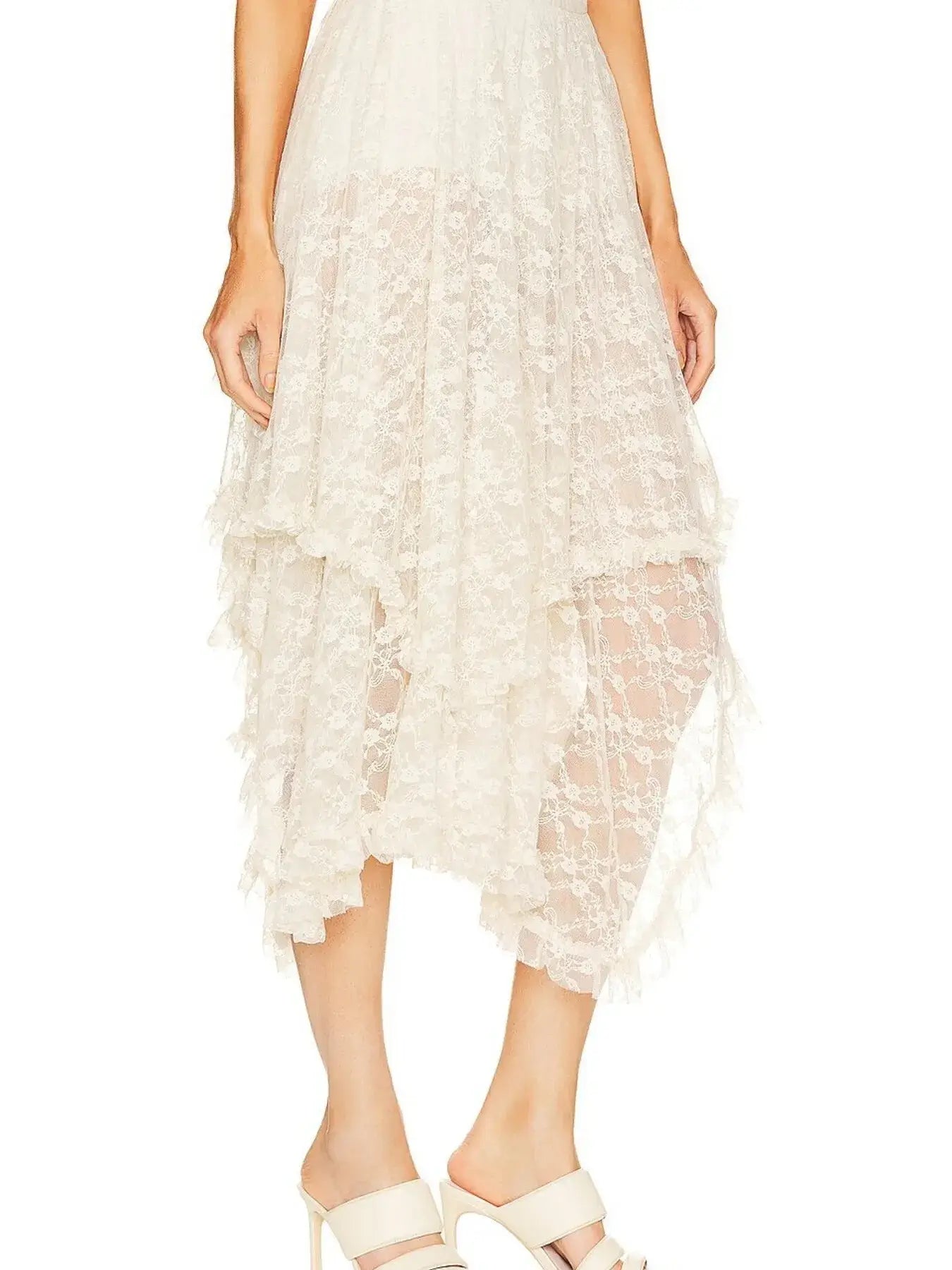 Asymmetrical lace midi skirt with sheer detailing, featuring a modern silhouette and elegant design, perfect for evening wear.